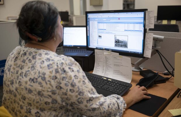Photograph of archivist Kerri Keil working on the MOHAI Collection database.