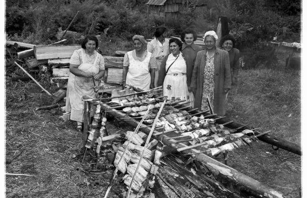 A group of Indigenous women cooking salmon over a fire on the Muckleshoot Reservation.