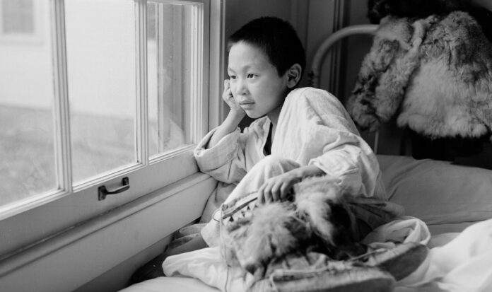 Young patient looking out of window at Firland Sanatorium, Seattle, December 1, 1954