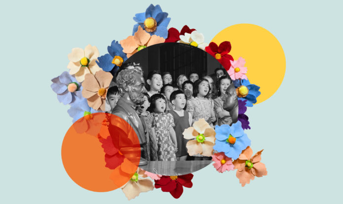 Asian children singing surrounded by flowers. A bust of Abraham Lincoln is in the foreground to the left.