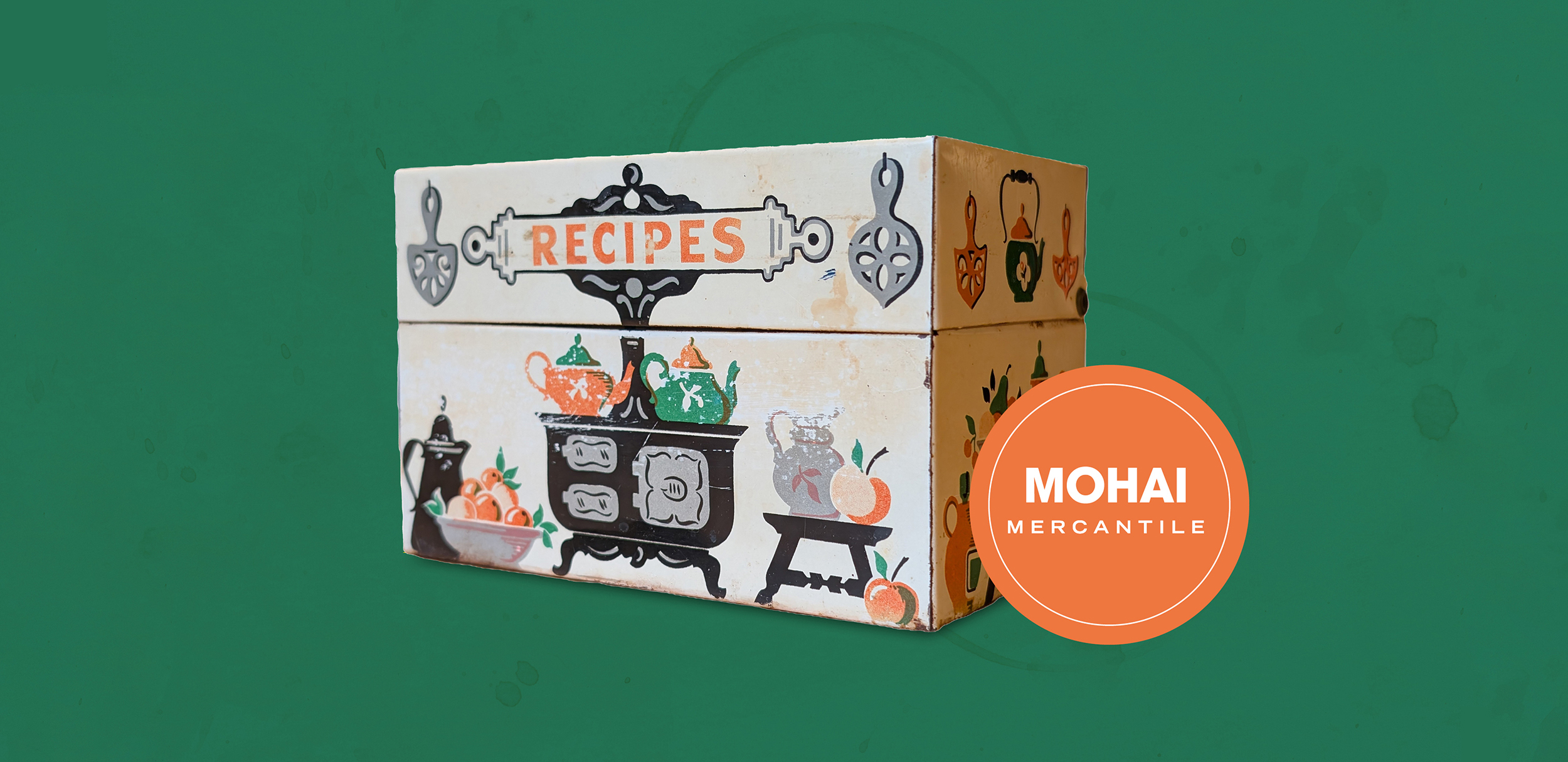 An antique recipe box against a green background.
