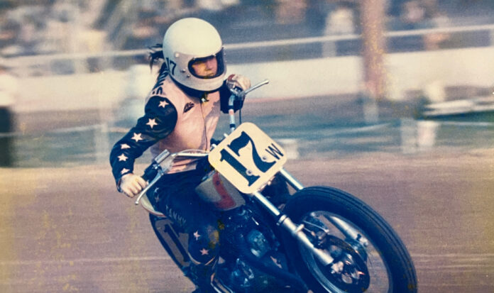 Tammy Sessions riding a motorcycle in a pink leather jacket.