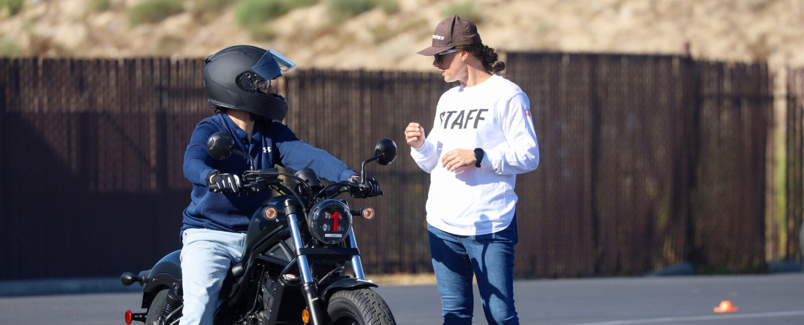 A staff member from the Motorcycle Safety Foundation speaks with a motorcycle rider.