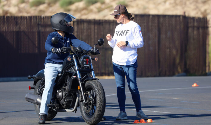 A staff member from the Motorcycle Safety Foundation speaks with a motorcycle rider.
