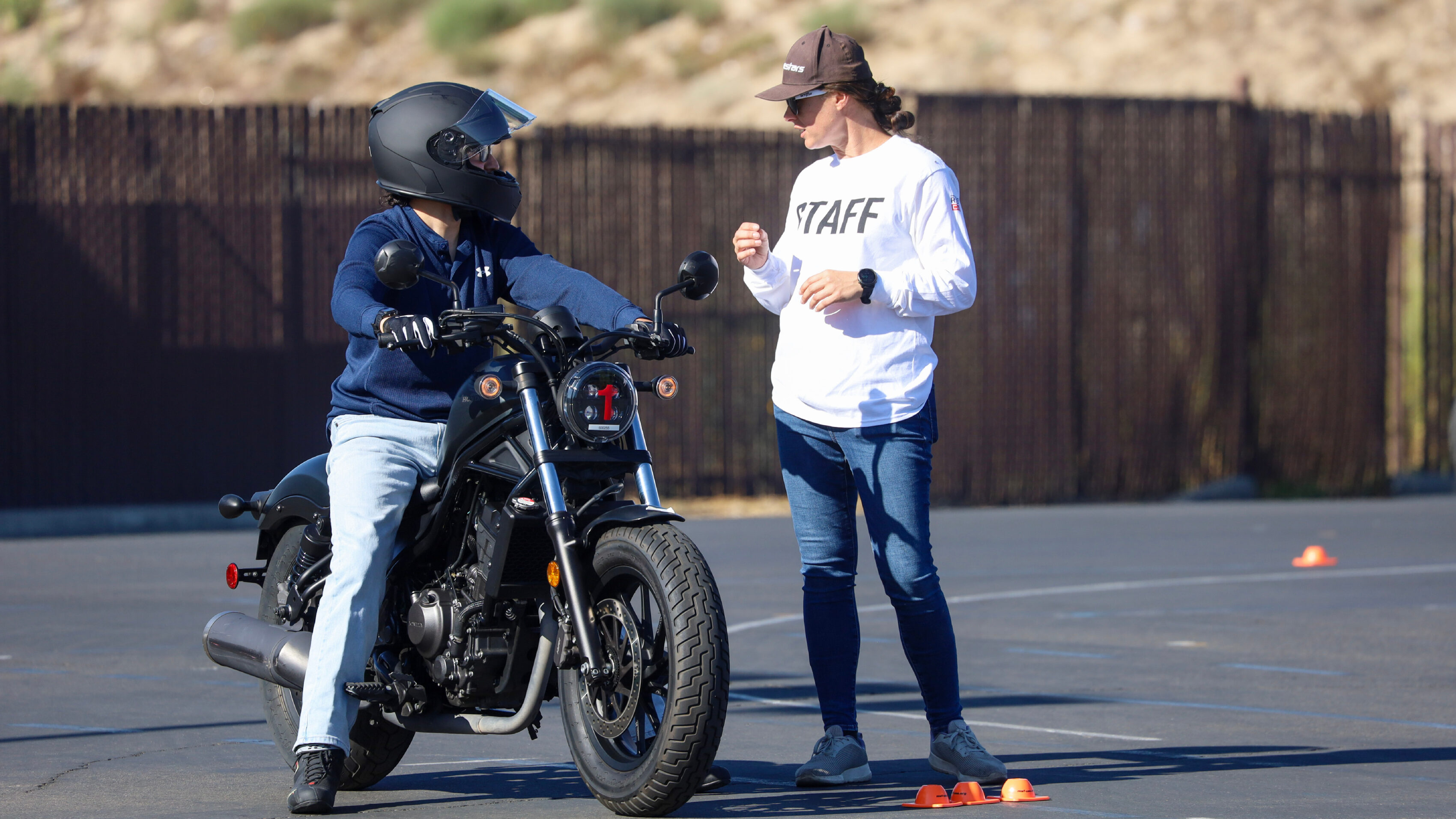 A staff member from the Motorcycle Safety Foundation speaks with a motorcycle rider.