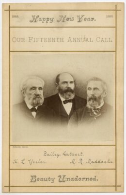 1886 New Year's greeting card titled "Our Fifteenth Annual Call," featuring a sepia photograph of Seattle mayors Bailey Gatzert, Henry L. Yesler, and M. R. Maddocks. Caption reads "Beauty Unadorned." From MOHAI's collection.
