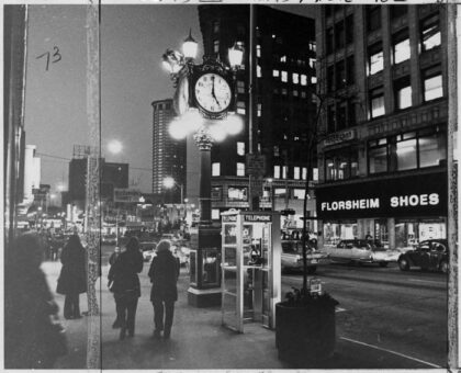 Tall outdoor street clock made by Joseph Mayer and Sons for Carroll's Fine Jewelry, standing at Fourth Avenue and Pike Street in downtown Seattle.