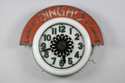 Round wall clock that once hung in the window of Ding Ho Laundry and Cleaners, a Seattle business founded by Chinese immigrants York and Arlene Luke in 1956.