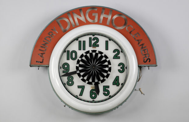 Round wall clock that once hung in the window of Ding Ho Laundry and Cleaners, a Seattle business founded by Chinese immigrants York and Arlene Luke in 1956.