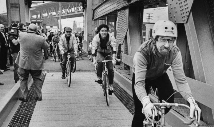 Bicyclists riding on the newly finished bicycle lanes of the University Bridge, Seattle, October 12, 1983.