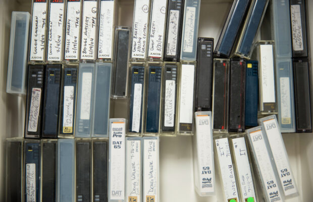 Photograph of several kinds of cassette and VHS tapes stored in the MOHAI collection.